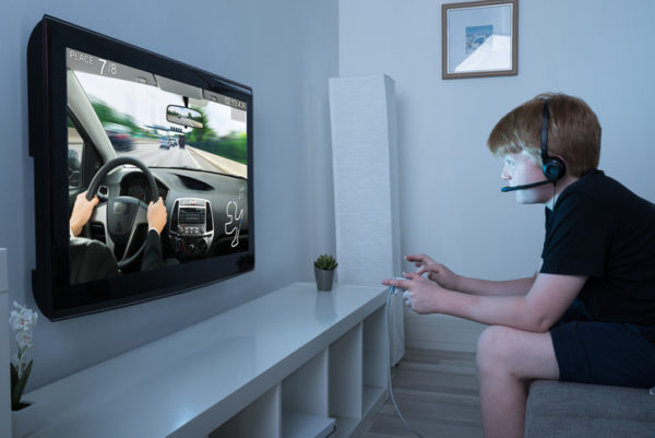 Boy Playing Car Game On Television